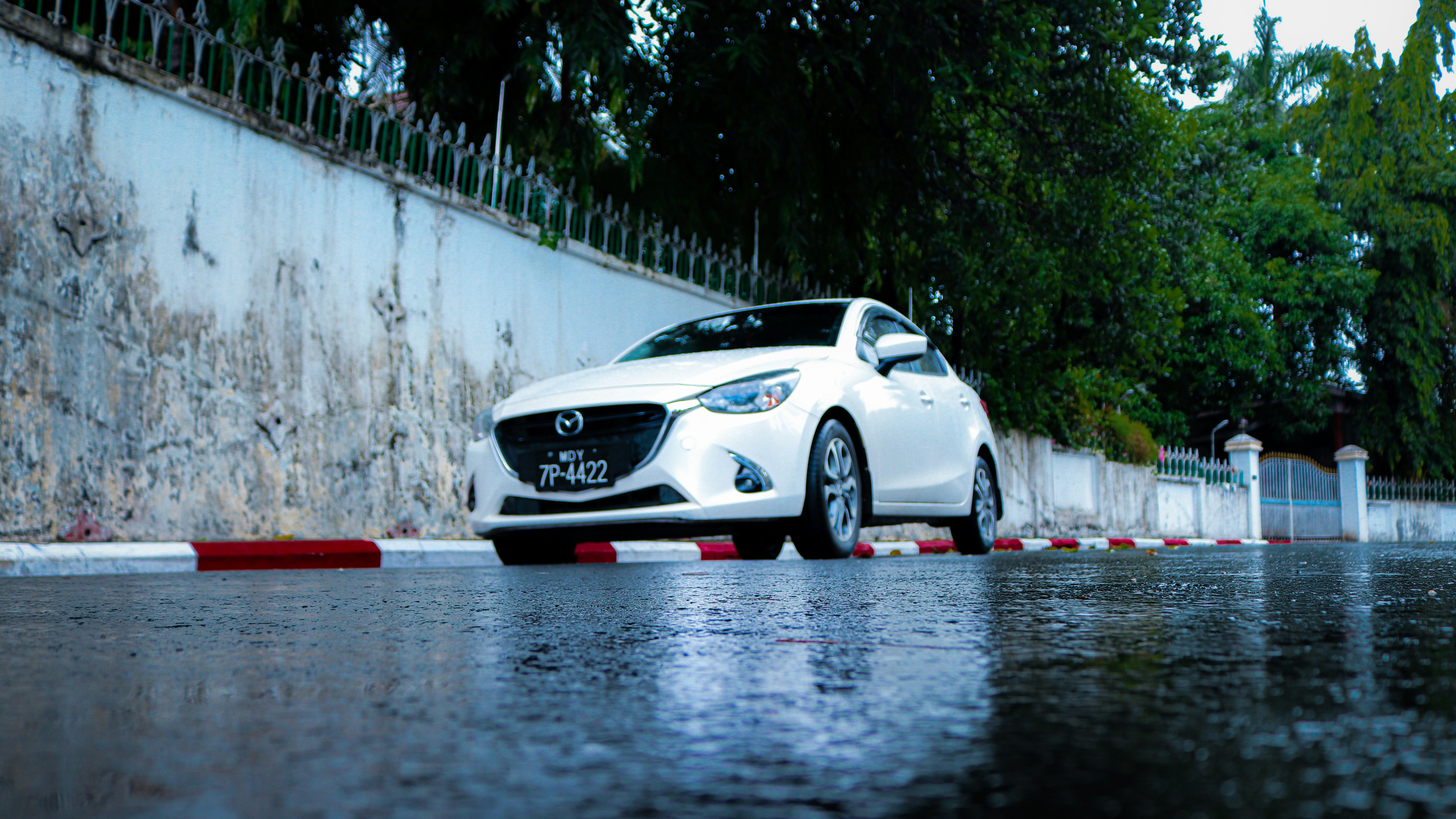 Yangon, Myanmar - Client car parked in the middle of nowhere on the clear street with some rains all over the place