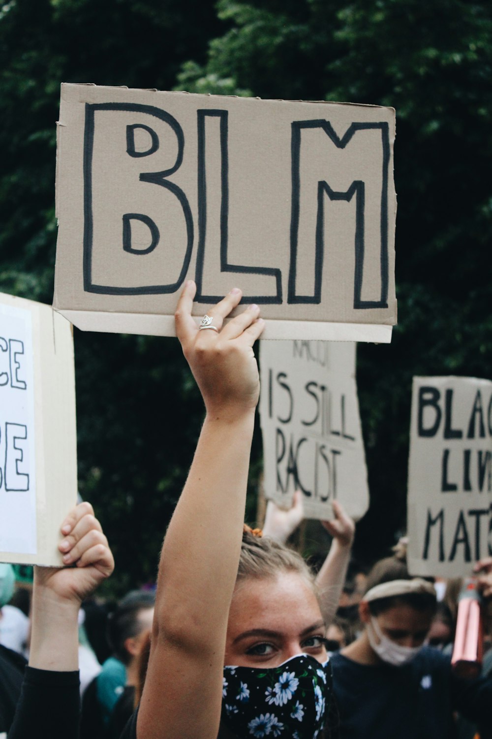 person holding white and black 9 printed board