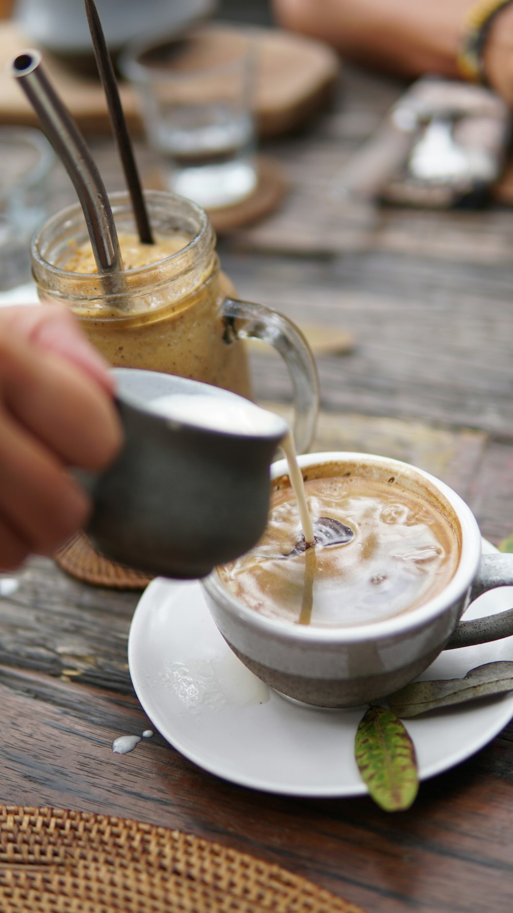 person holding white ceramic mug with coffee