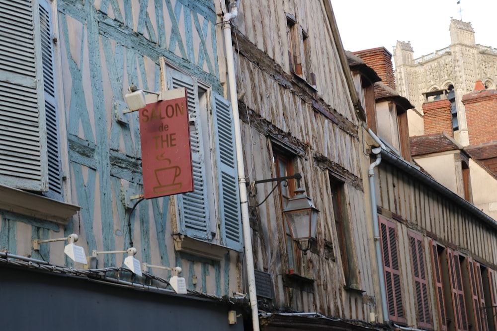 brown wooden signage on gray concrete building during daytime