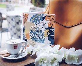 white flowers on brown leather bag