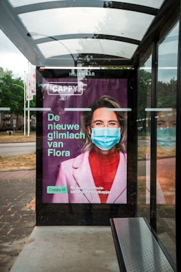 woman in pink shirt wearing blue sunglasses