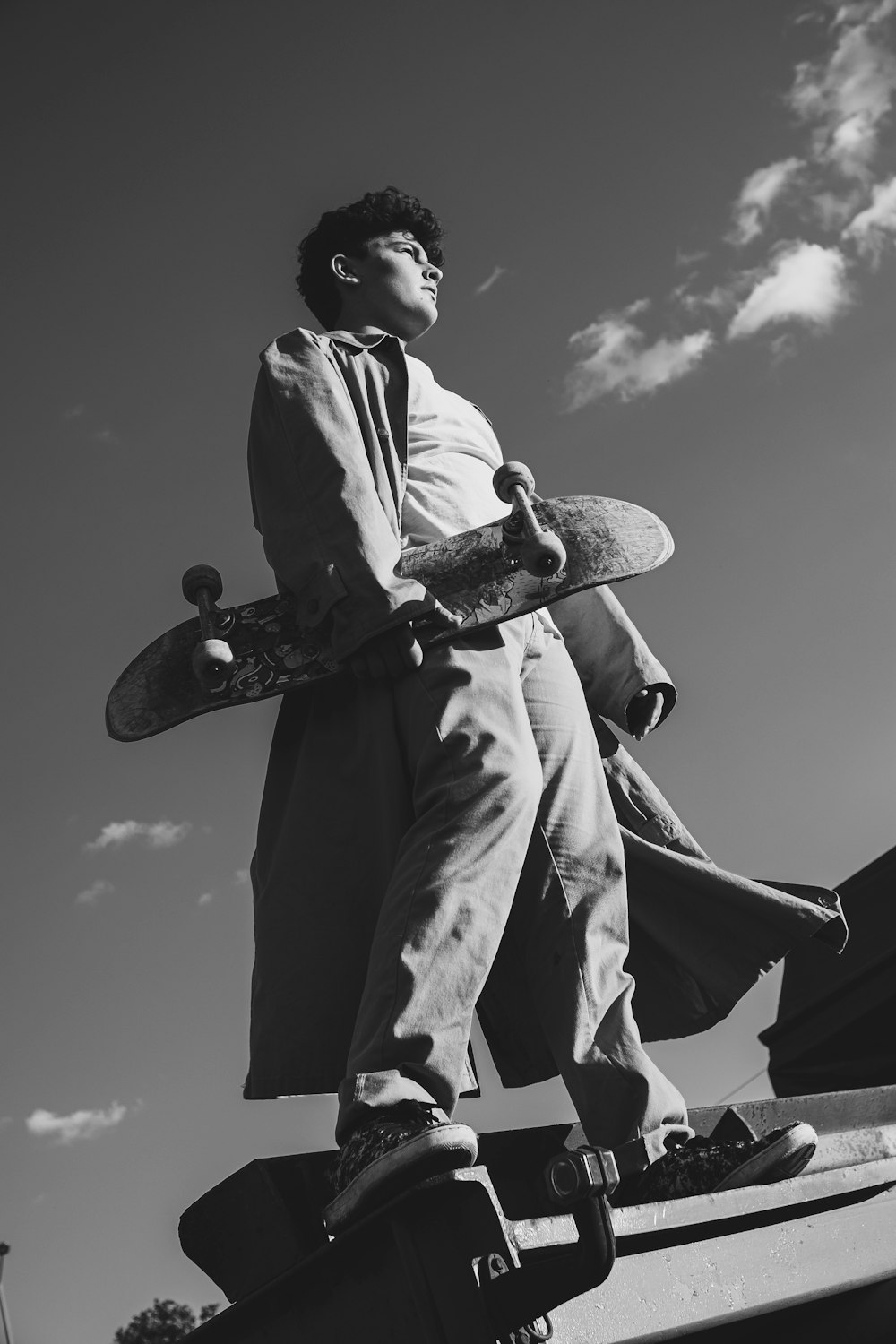 grayscale photo of man in dress shirt and pants holding flag