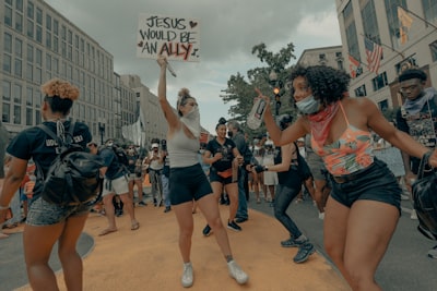 people standing on road during daytime black history teams background