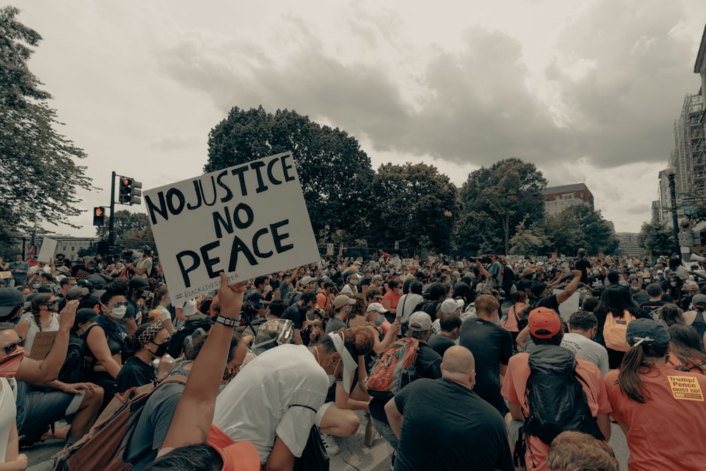 a large crowd of people holding up signs