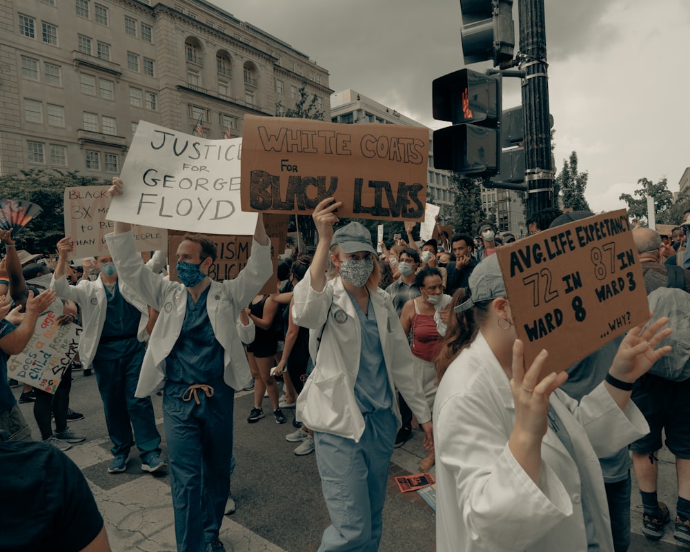 people holding signage during daytime