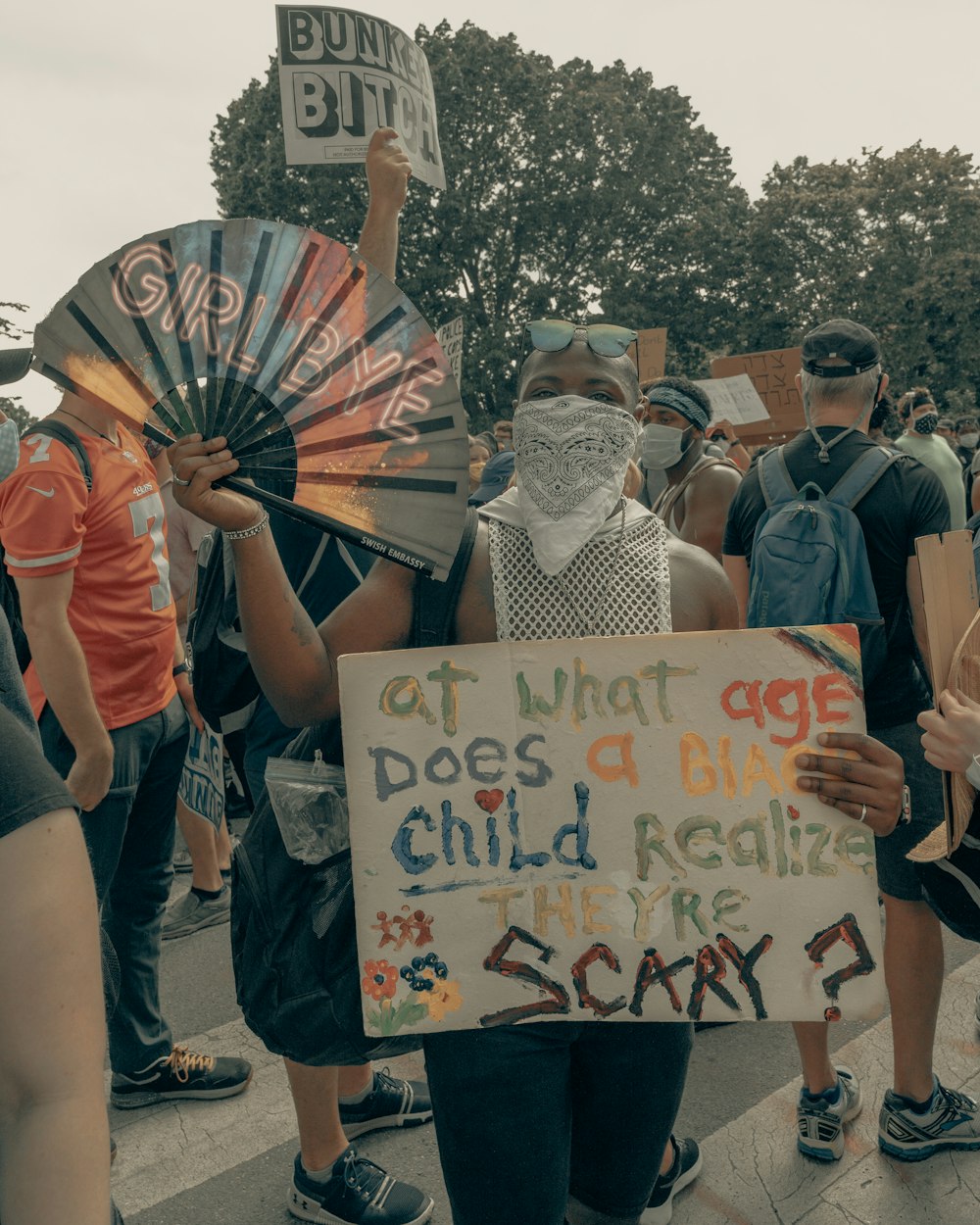 people holding happy birthday banner during daytime