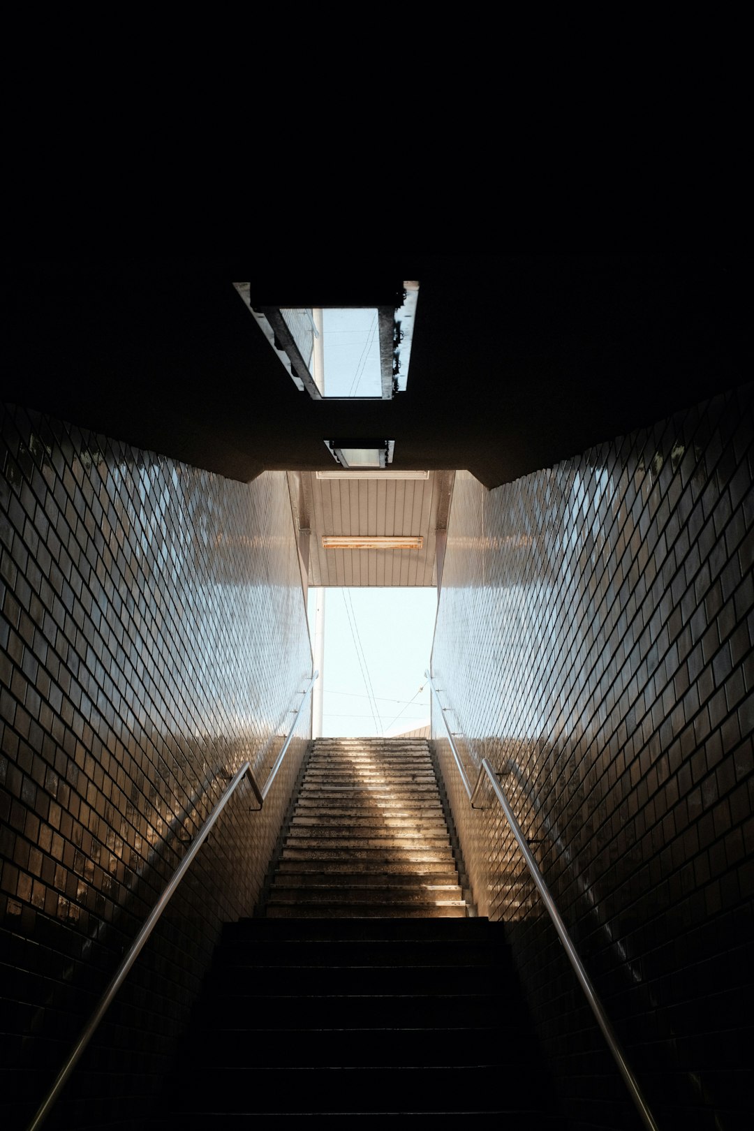 brown wooden staircase in tunnel