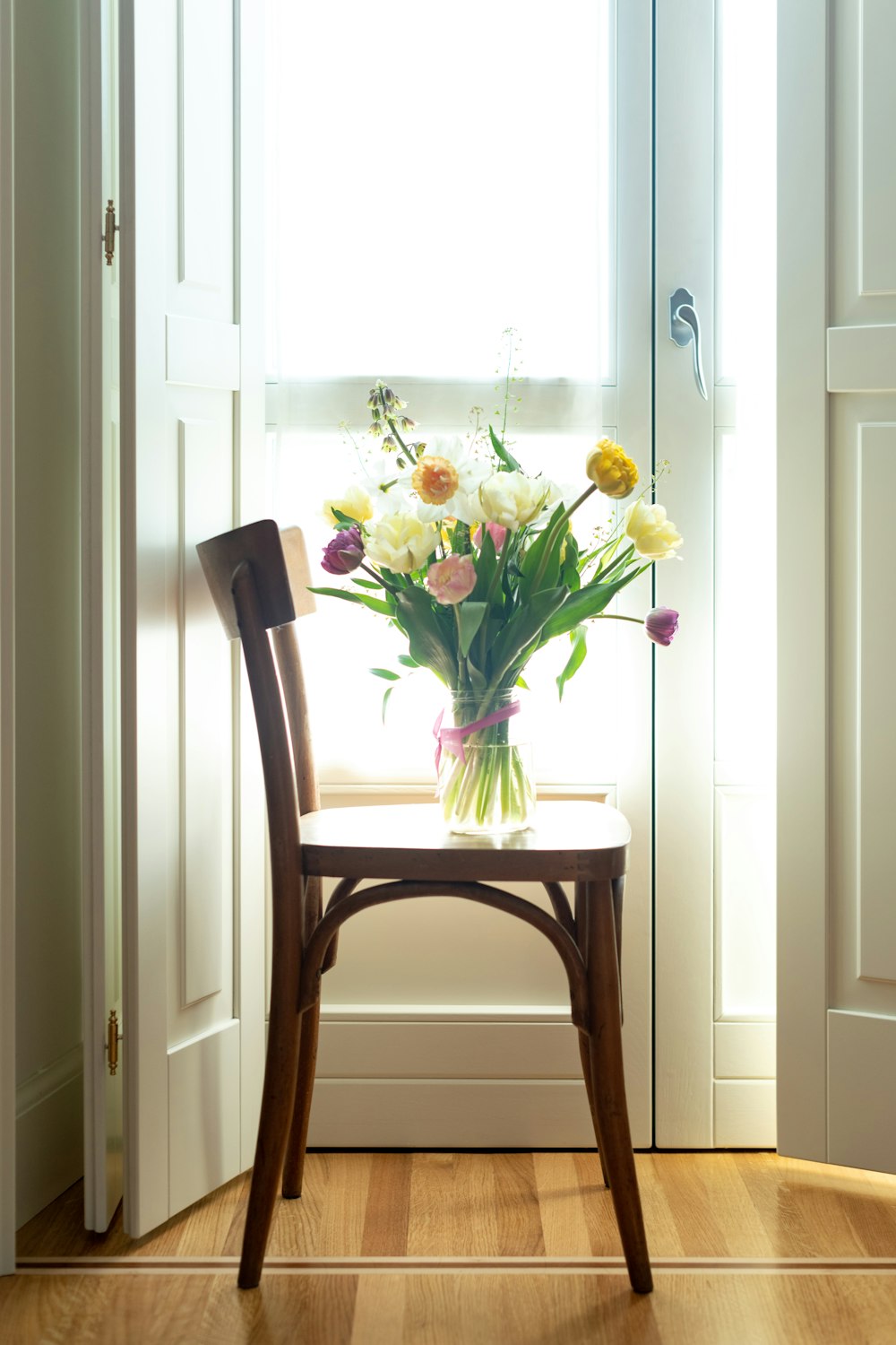 yellow and red flowers on brown wooden table