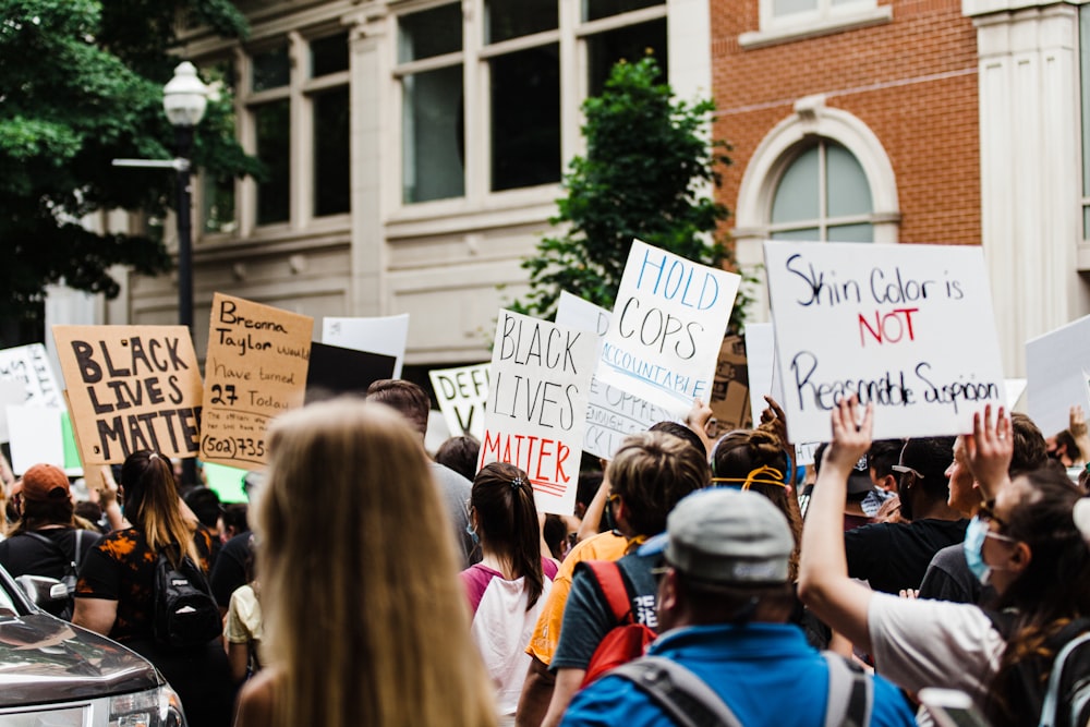 people holding white printer paper during daytime