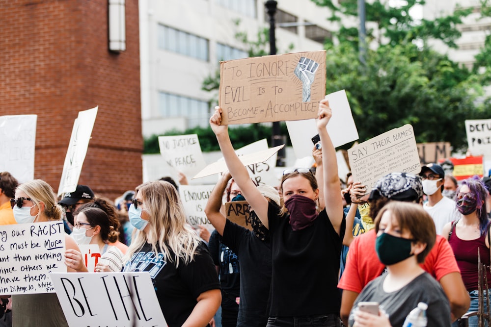 people holding brown cardboard box during daytime