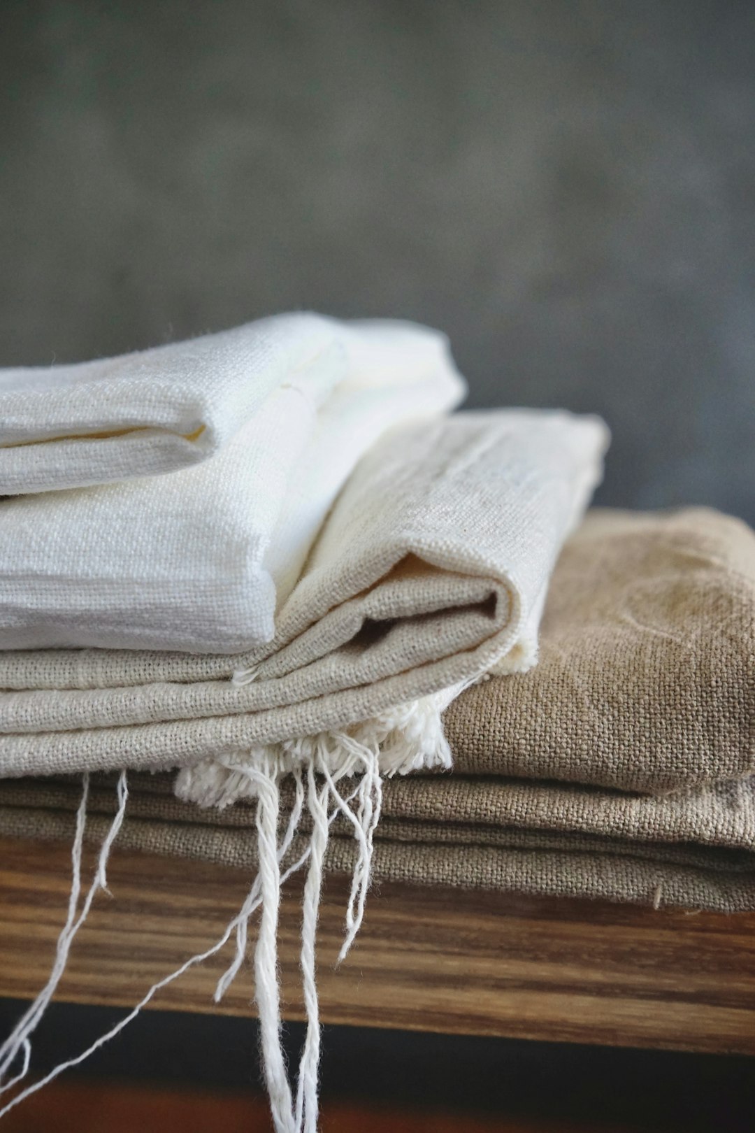  white textile on brown wooden table sheet