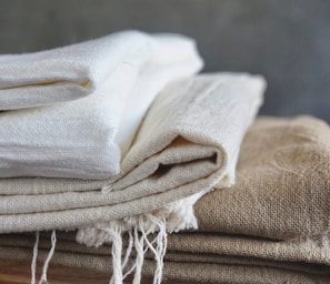 white textile on brown wooden table