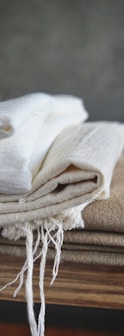 white textile on brown wooden table