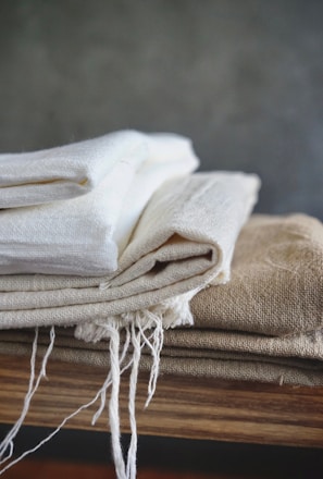 white textile on brown wooden table