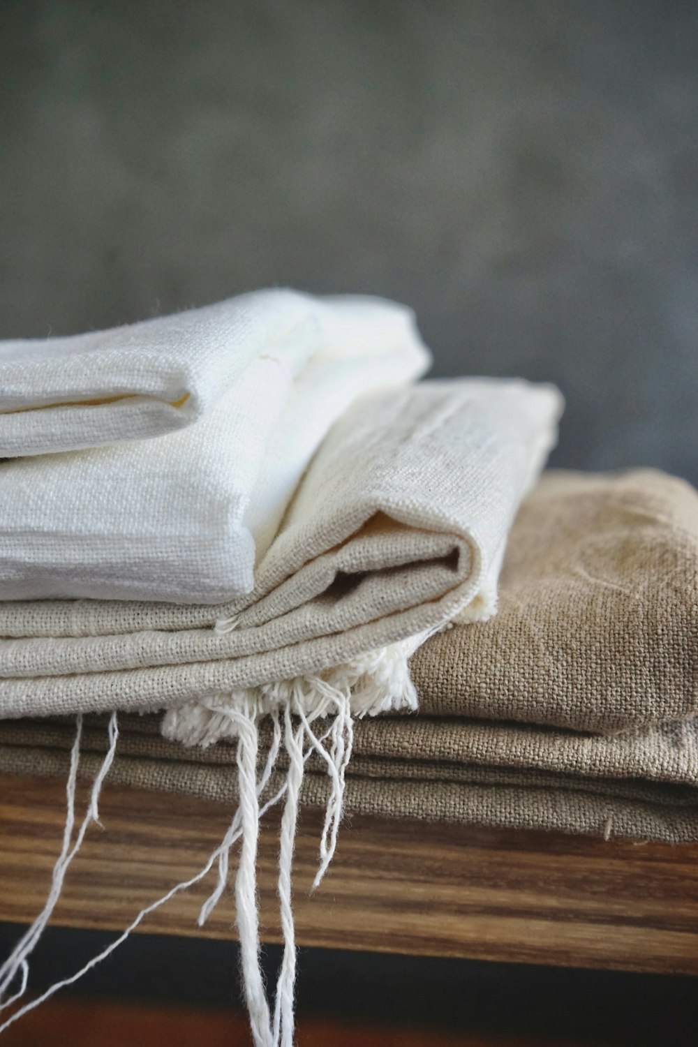 white textile on brown wooden table