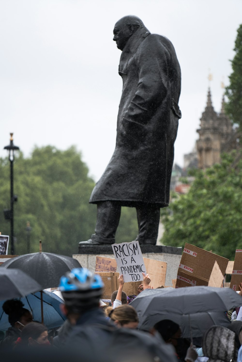 person in black coat holding brown paper bag