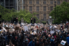 A crowd of protesters holding signs in a city square.