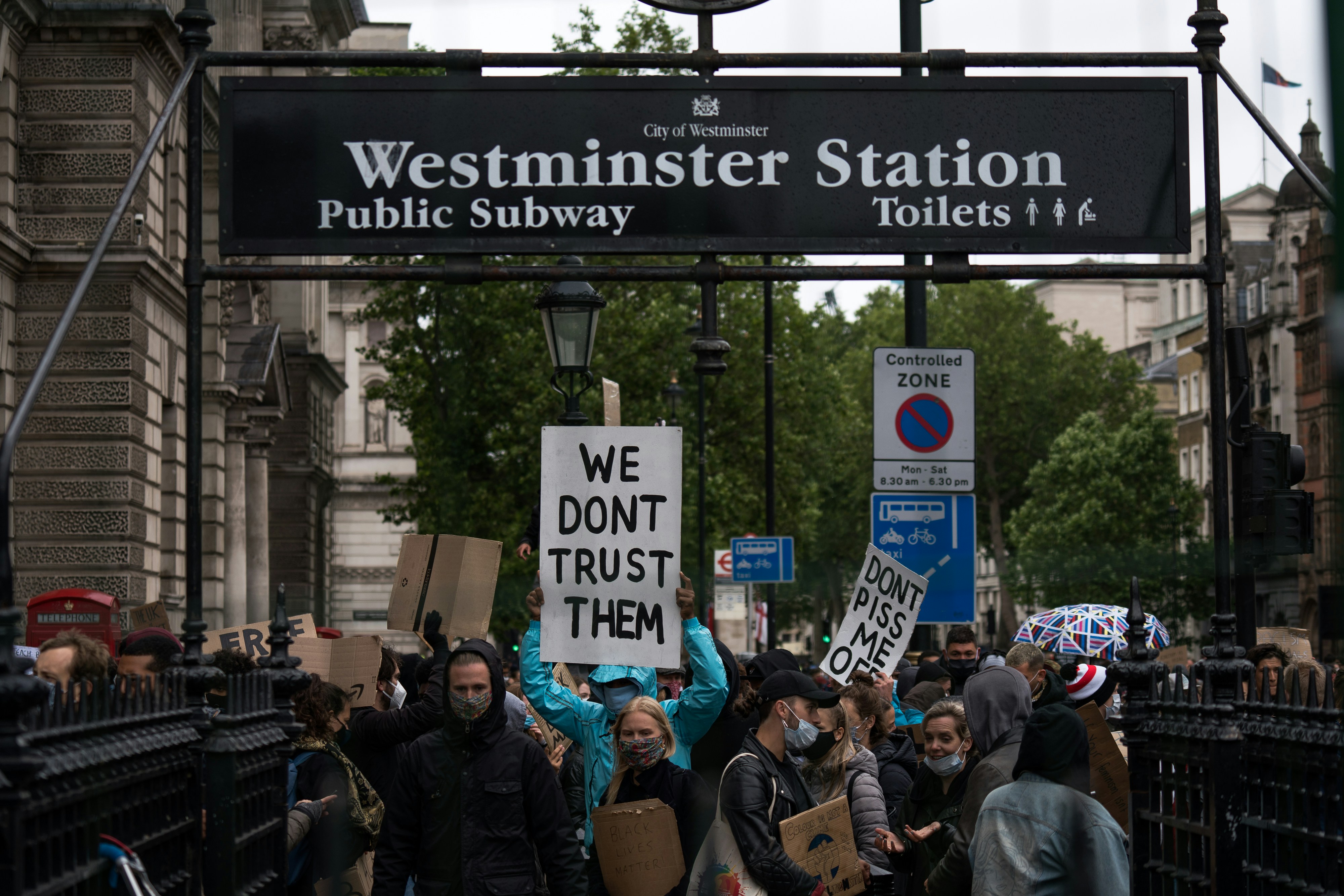 people standing near black and white signage during daytime