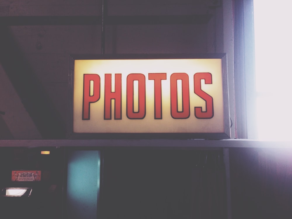 Un cartello che dice foto sopra una cabina telefonica