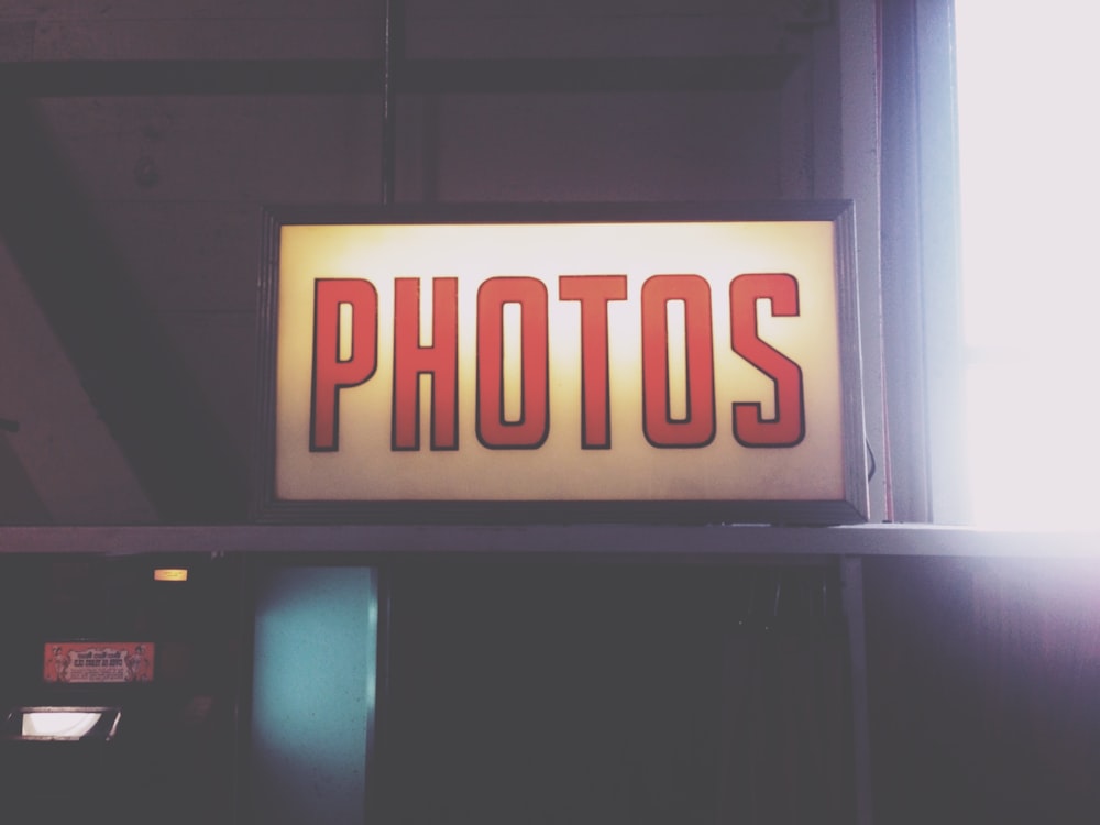 a sign that says photos above a phone booth