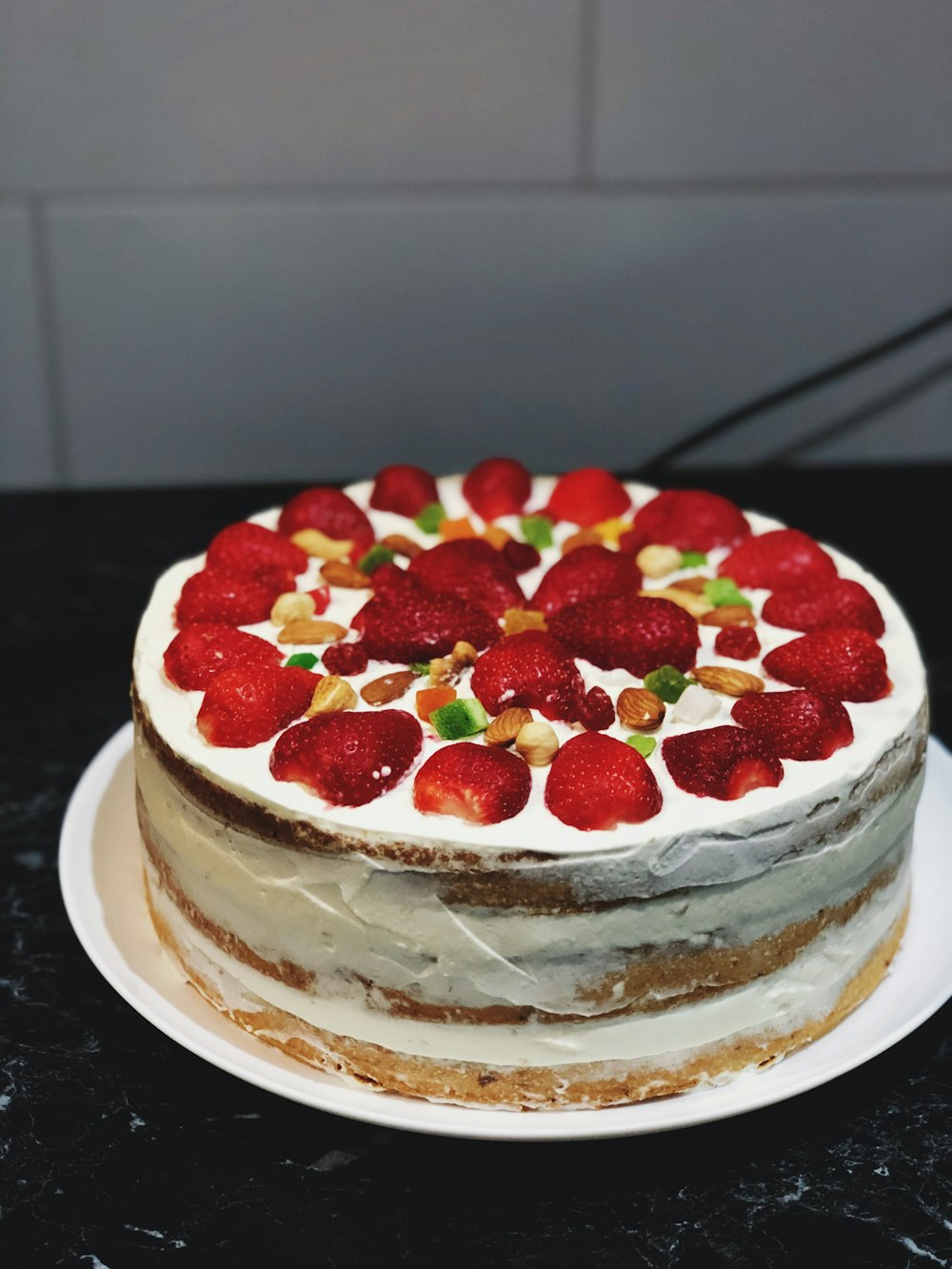 strawberry cake on white cake stand