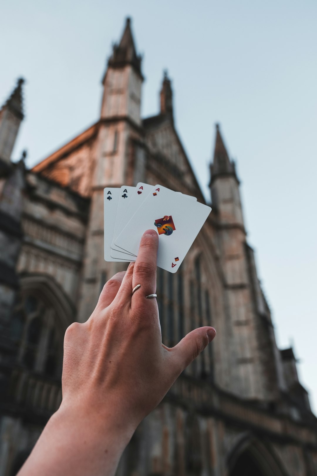 person holding 2 of spade playing card
