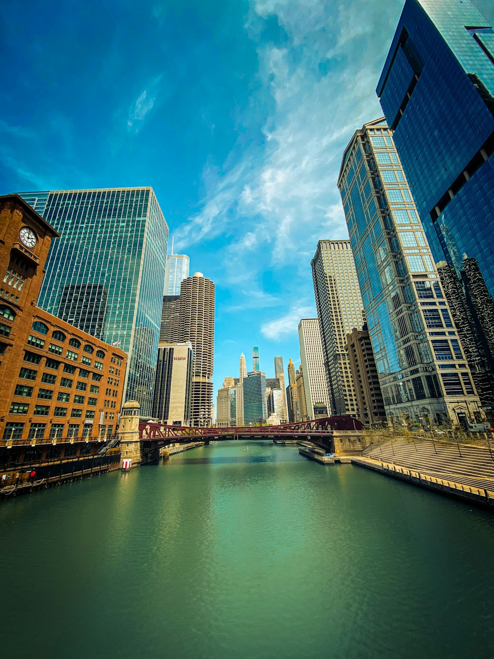 high rise buildings near body of water under blue sky during daytime