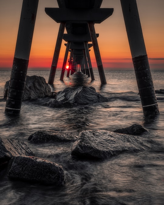 brown wooden dock on body of water during daytime in Badalona Spain