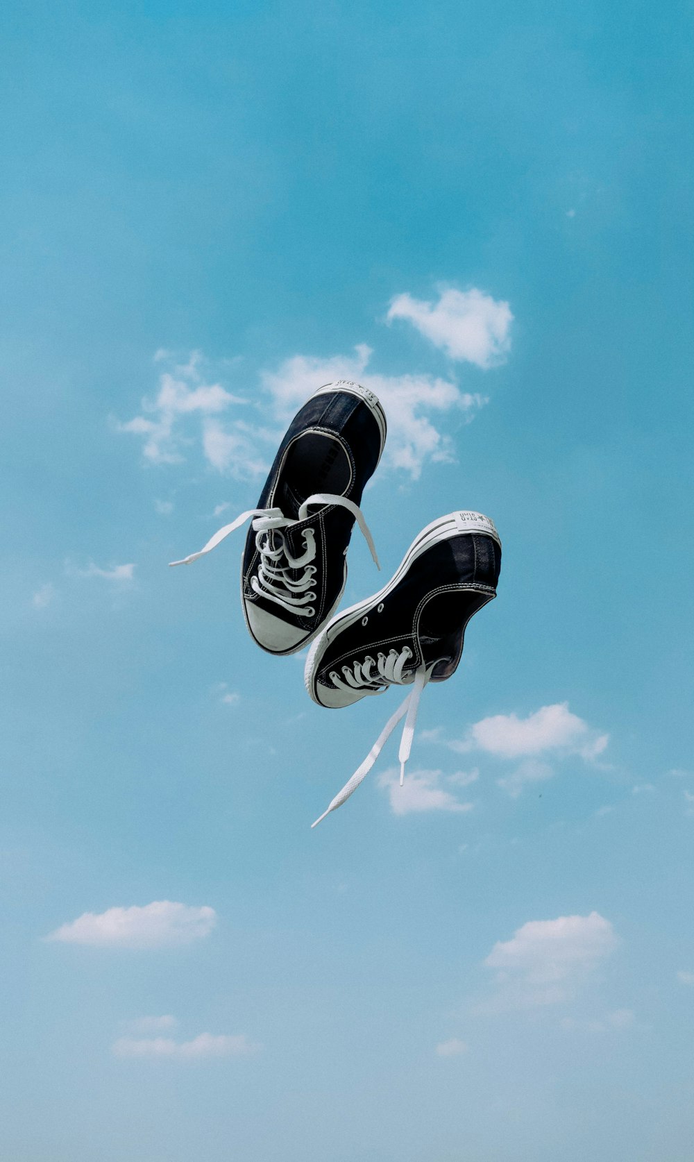 black and white sneakers under blue sky during daytime