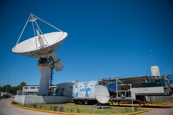 white satellite dish on roof top during daytime