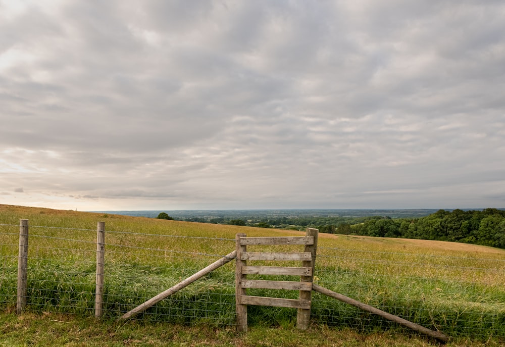 green grass field under white clouds during daytime