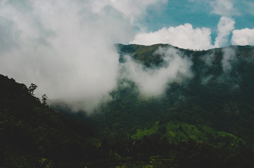 green mountain under white clouds during daytime