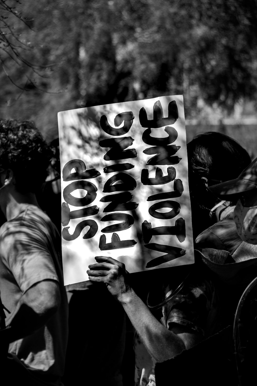 grayscale photo of woman holding happy birthday signage