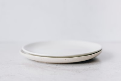 white round plate on white table dish teams background