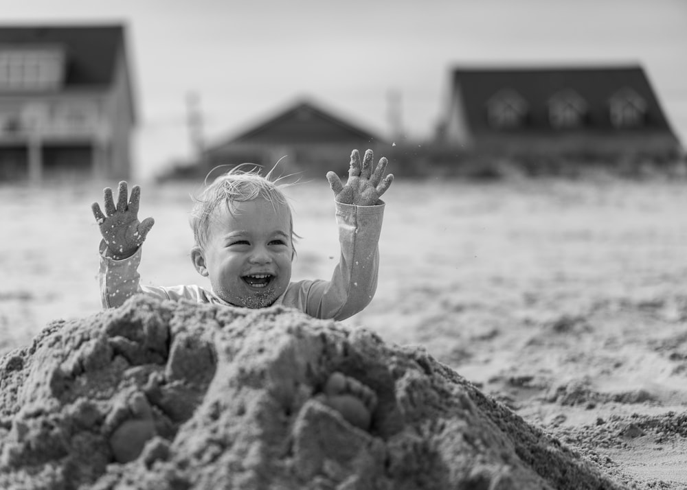 grayscale photo of girl in white shirt on beach