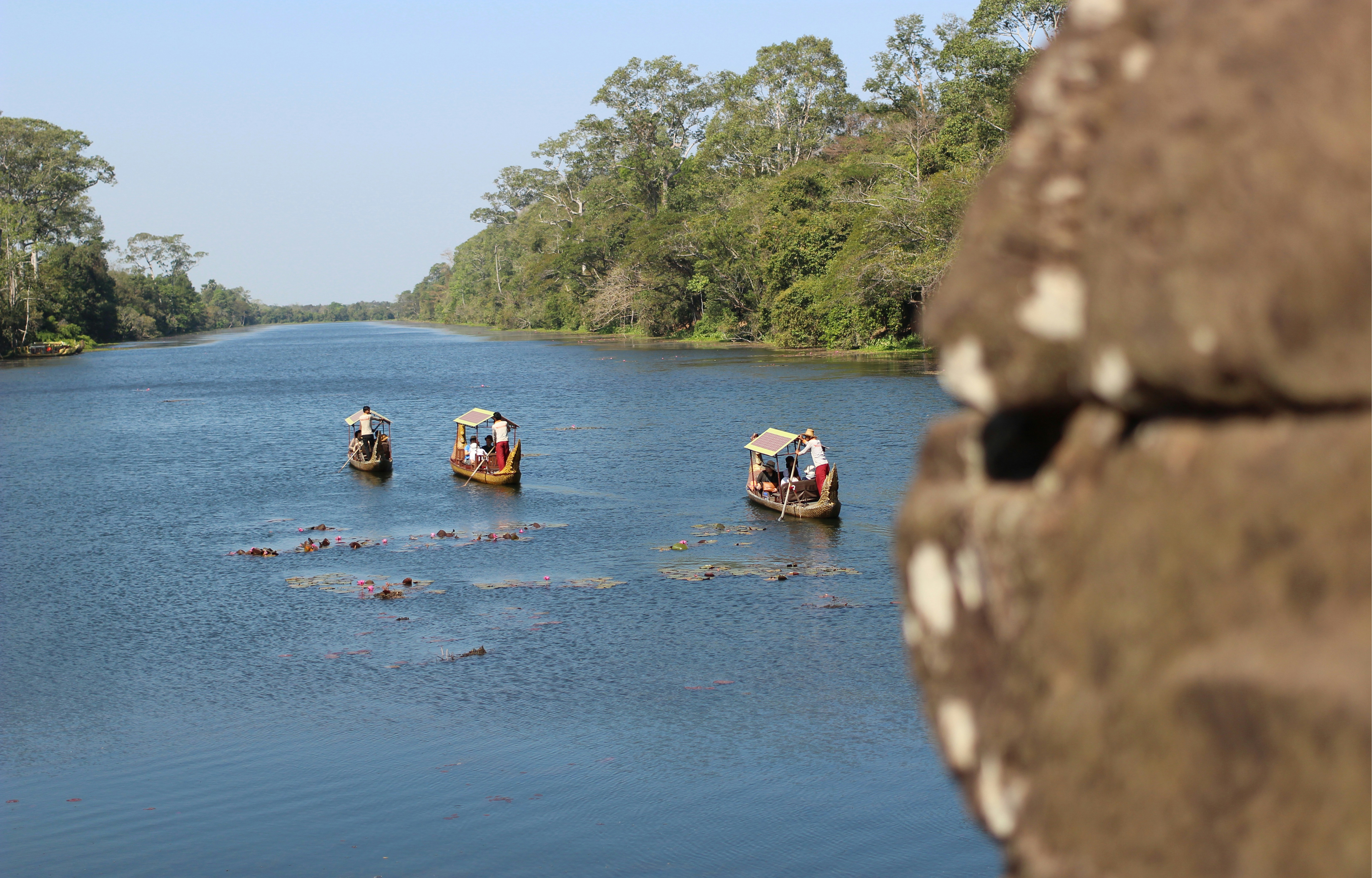 people riding on boat on river during daytime