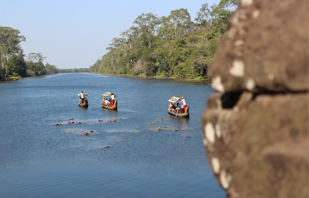 people riding on boat on river during daytime