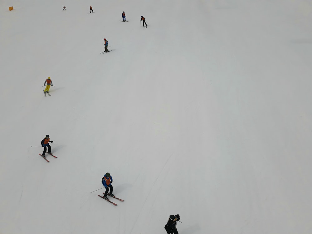 people riding ski lift on snow covered ground during daytime