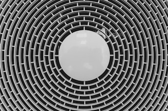 black and white round illustration resembling a fan