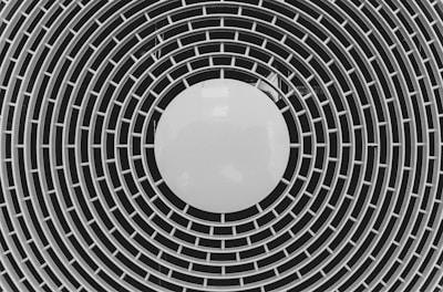 black and white round illustration resembling a fan