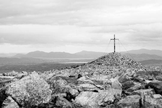 grayscale photo of a windmill on a hill in Donegal Ireland