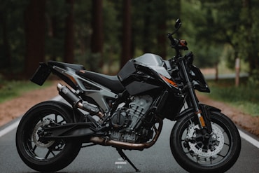 black and silver naked motorcycle on road during daytime