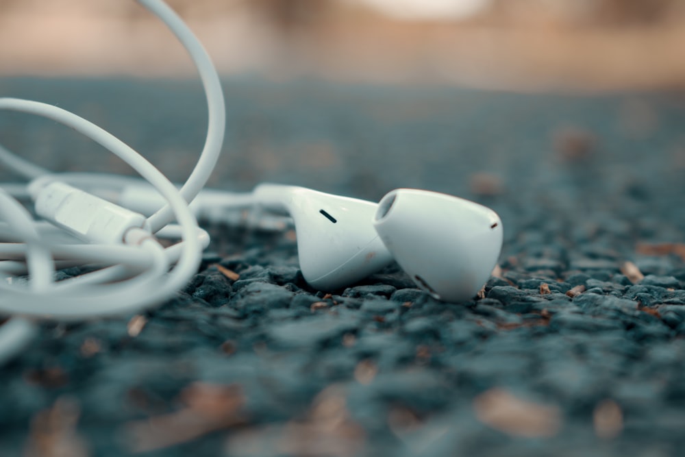 white corded headphones on ground