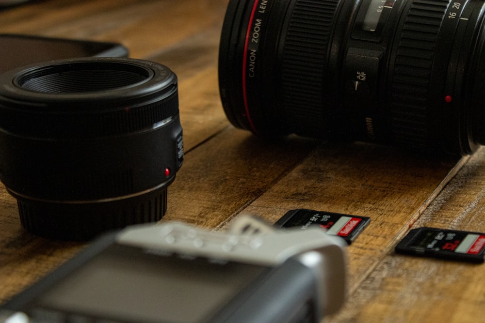 black and gray camera lens on brown wooden table