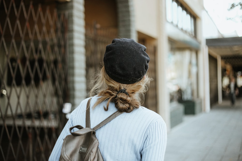 woman in white long sleeve shirt wearing black knit cap