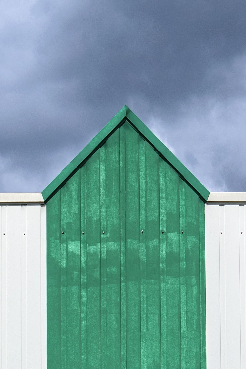 green wooden house under blue sky
