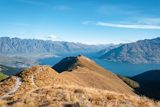 brown grass field near mountain during daytime