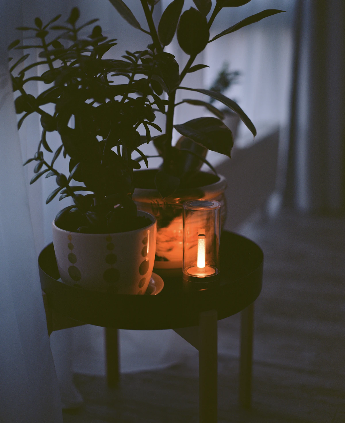 Ceramic mug and candle on a warm wooden surface