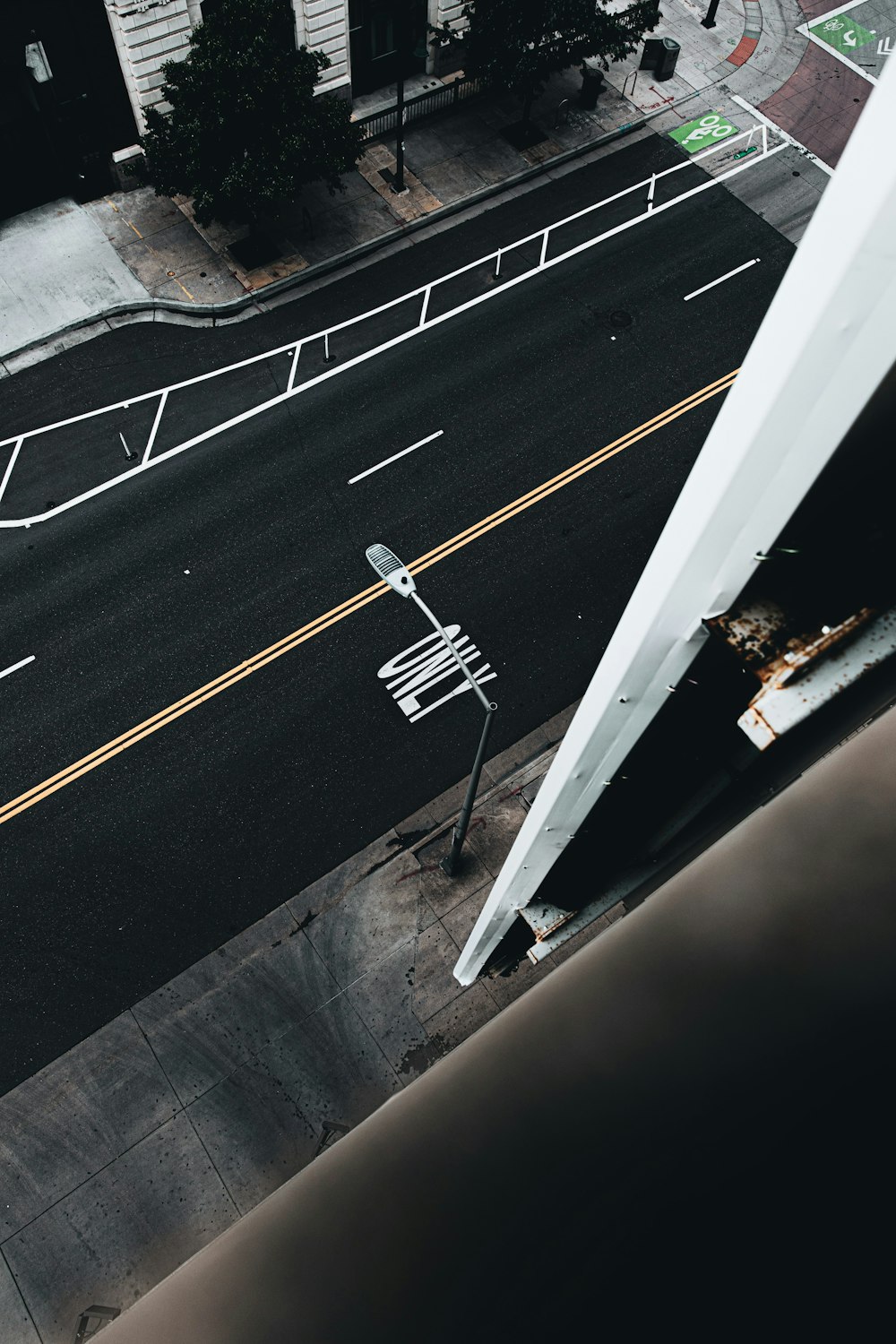 white metal railings on gray concrete road